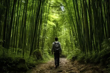 Gordijnen Hiker in a dense bamboo forest © KerXing