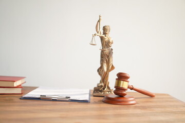 A judge's gavel, a symbol of authority, rests on a grey background. Its weight signifies the...