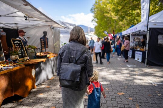 Weekend country market in a park in Australia. Family&rsquo;s and people at a Farmers market selling fruit and vegetables