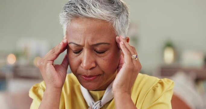 Old woman, headache and temple pain in home for brain fog vertigo in retirement for burnout, tired or mIgraine. Female person, hands and massage for stress pressure with problem, wellness or dizzy