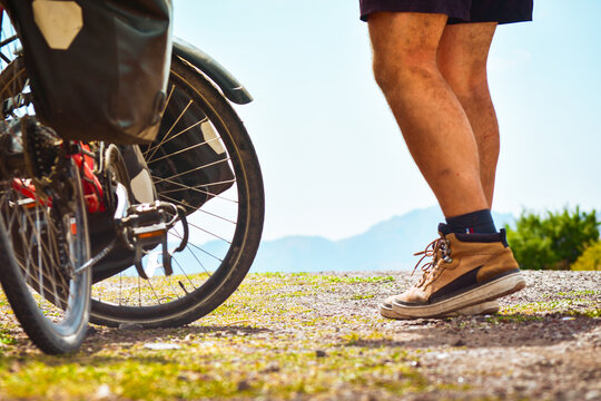 Isolated fit young caucasian male person stand by bicycle with mountains background outdoors in caucasus mountains. Achievement , inspiration, challenge and determination concept