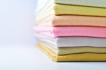 Fototapeta na wymiar stack of colourful cotton clothes, pile of clothing on white background