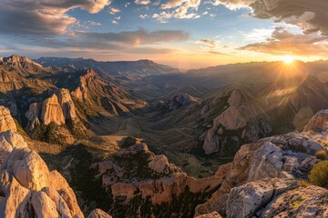 Fototapeta premium A panorama of a breathtaking sunset over a vast mountain range, showcasing the dramatic peaks bathed in warm light