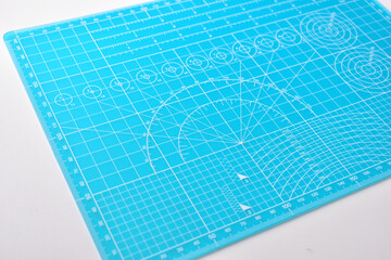 blue cutting mat board on white background with line and scale measure guide pattern for object art design, tool equipment of diy craft work - 782729288