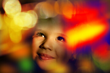 Happy smiling child girl in the Virtual World. Neon lighting. Ethereal space. Blurred colorful flashing light. Futuristic, video game