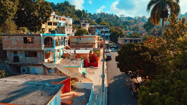 Small tropical town city life concept background. Morning on the deserted streets of the Dominican Republic. Old picturesque street. Modern urban landscape of Latin America.