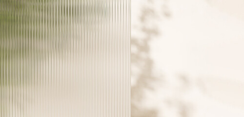 Fresh beautiful green tropical tree behind transparent fluted reeded glass in dappled sunlight for modern, elegant, luxury fashion, beauty, cosmetic, skincare, body care, product background 3D © Sue Tansirimas