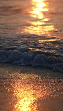 A summer ocean sunset sea background with small waves on the water's surface in lights from sunrise
