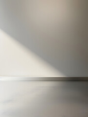 A white wall with a shadow on it. The wall is bare and empty. The shadow is the only thing that adds some life to the room