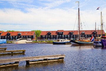 Waterfront with colorful wooden houses in Dutch Reitdiep harbor, Groningen town, Netherlands.