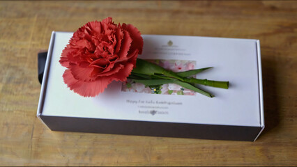 Carnations attached to a gift box