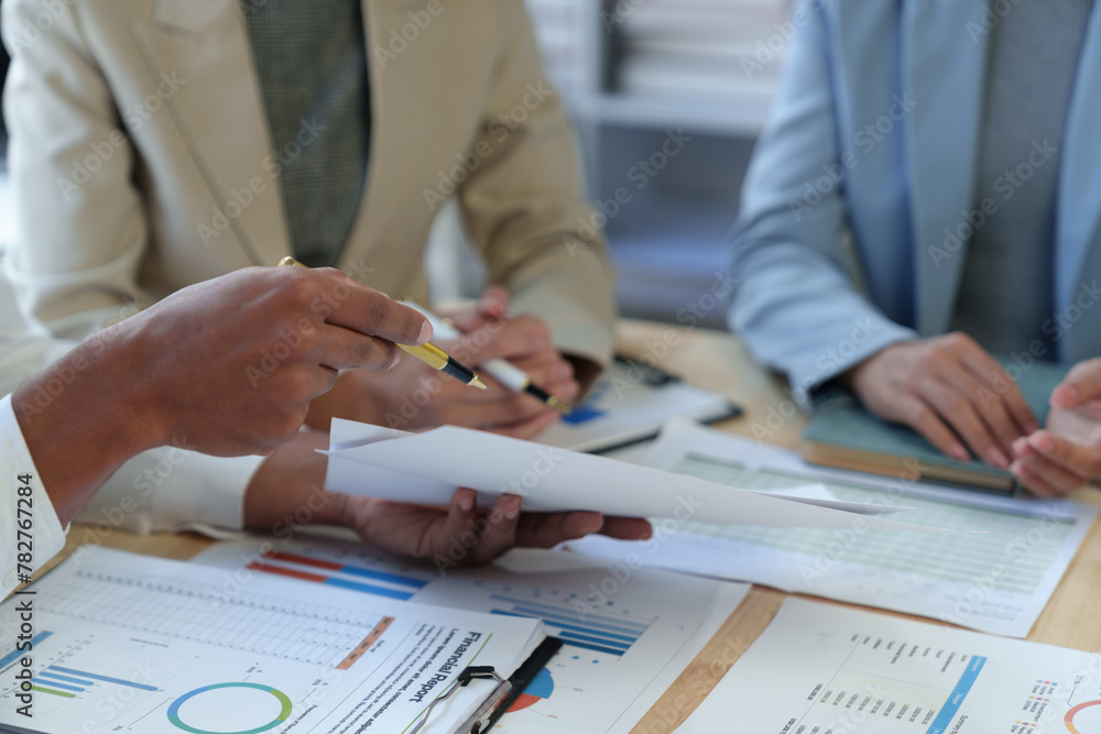 Poster team of business people analyzing, discussing, calculating earnings from earnings charts and graphs 