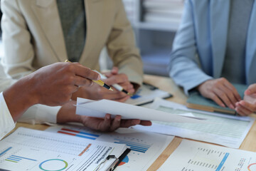 Team of business people analyzing, discussing, calculating earnings from earnings charts and graphs Growth with laptop computers and brainstorming strategies for new projects. startup business ideas