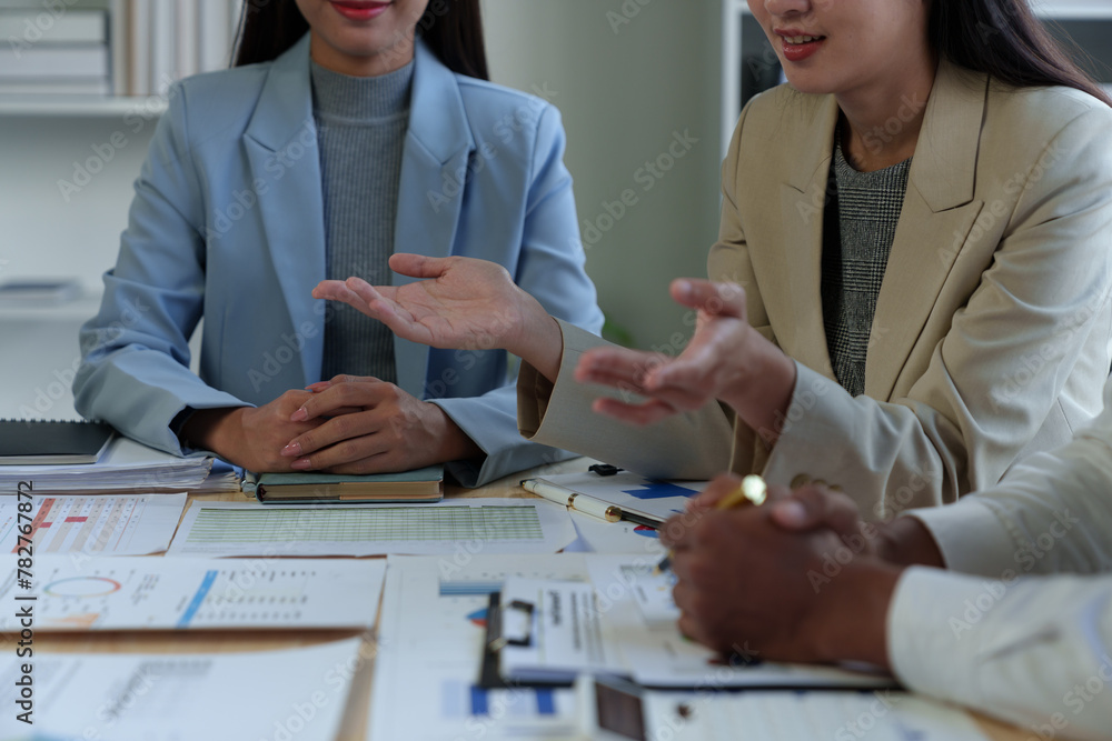 Poster team of business people analyzing, discussing, calculating earnings from earnings charts and graphs 