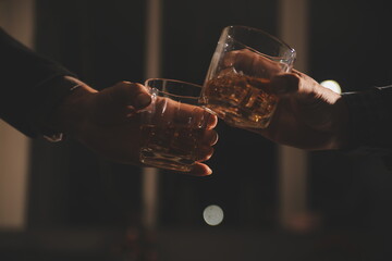 Celebration night, pour whiskey into a glass. Give to friends who come to celebrate - obrazy, fototapety, plakaty