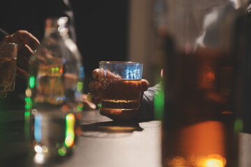 Obraz na płótnie Canvas Celebration night, pour whiskey into a glass. Give to friends who come to celebrate