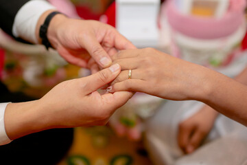 The groom is wearing a ring for the bride to show that they are committed to marrying each other as...