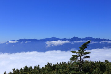 The Southern Alps floating in the sea of clouds seen from the top of Mt.Amigasa