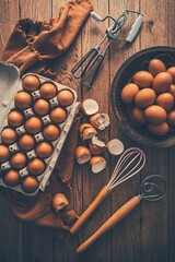 Fresh organic eggs with kitchen and baking utensils
