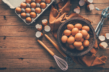 Fresh organic eggs with kitchen and baking utensils