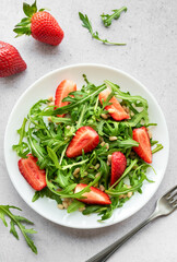 Fresh Strawberry Arugula Salad With Pine Nuts Served on a Bright Day
