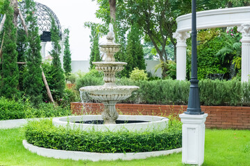 Luxury water fountain in the park,The three tiered fountain in english garden,Home garden in retro...