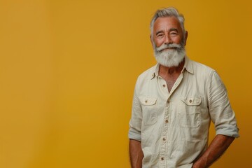 A man with a white shirt and gray hair is smiling at the camera