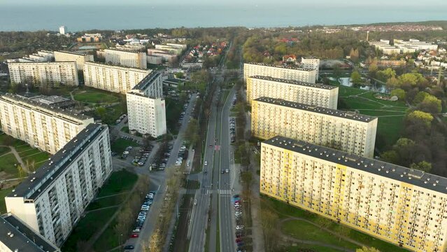 Aerial shot captures a broad avenue slicing through a uniform residential district, lined by rows of large apartment blocks - Gdańsk, Żabianka.