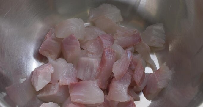 seasoning the fish for teh ceviche with chili