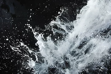 Foto op Aluminium Splashes of water on a black background,  close-up © Cuong