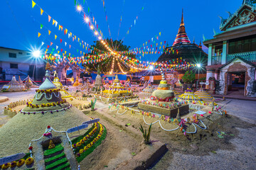 PHITSANULOK, THAILAND - April 11,2024:Thai people come to build the sand Pagoda for return the sand...