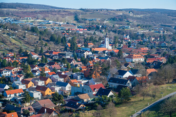 View of the houses in the valley and the white church. Autumn. Sunny weather.