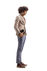 Full length profile shot of a young slim man holding a book