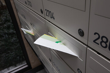 Mail, mock-up and paper documents stuck in mailbox