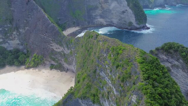 Drone aerial footage over a cliff in Bali. Indonesia beautiful sea landcape. Adventure travel agency.