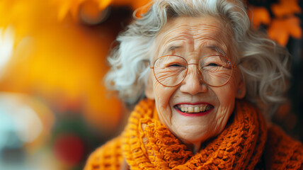 A asian woman with glasses, a yellow scarf is smiling. She looks happy and content. Concept of...