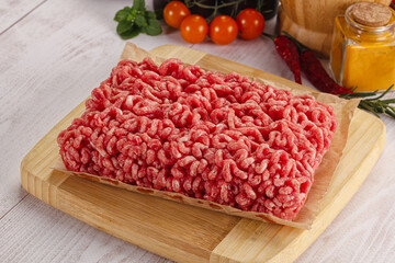 Raw minced beef meat over board