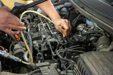 close-up photo of a mechanic's hands repairing a car diesel engine