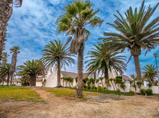 Street promenane in Walvis Bay, Namibia, with beautiful palm tree forests and dutch cape style houses