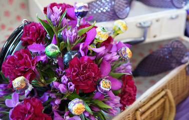 A bouquet of many flowers of purple color in a basket