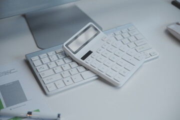 Laptop and paperwork on conference table