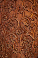 Texture of wooden door with carved motifs for background