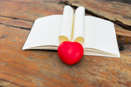 Open book with pages forming heart shape.background