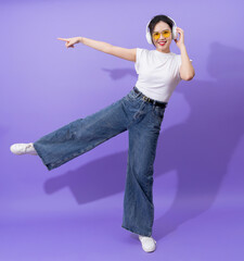 Young Asian teenager on purple background