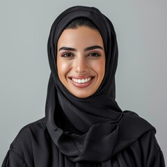 Naklejka premium A smiling Muslim young woman in a black hijab during Ramadan. Fictional Character Created by Generative AI.