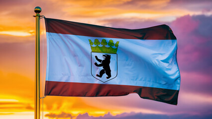 Berlin Waving Flag Against a Cloudy Sky at Sunset.