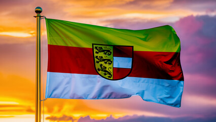 Carinthia Waving Flag Against a Cloudy Sky at Sunset.
