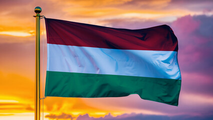 Hungary Waving Flag Against a Cloudy Sky at Sunset.