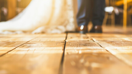Bride in white gown and groom in blue suit stand together, floor perspective, intimate wedding moment captured, soft focus.