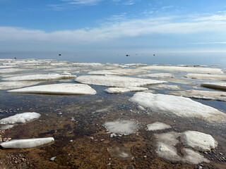 White ice floes float on the surface of the water. Spring ice drift.